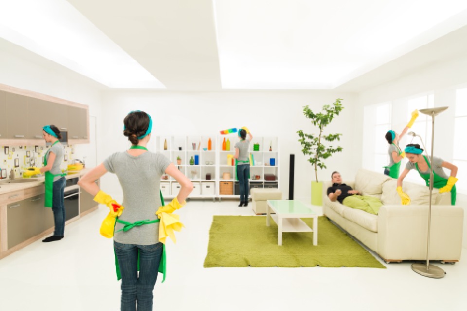 Personas con delantal verde limpian un salón-cocina